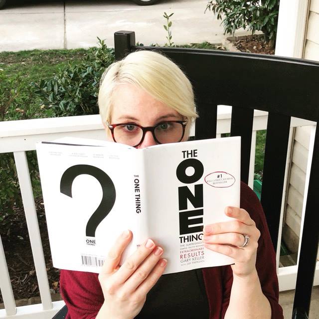 Jenny holding the book The One Thing 